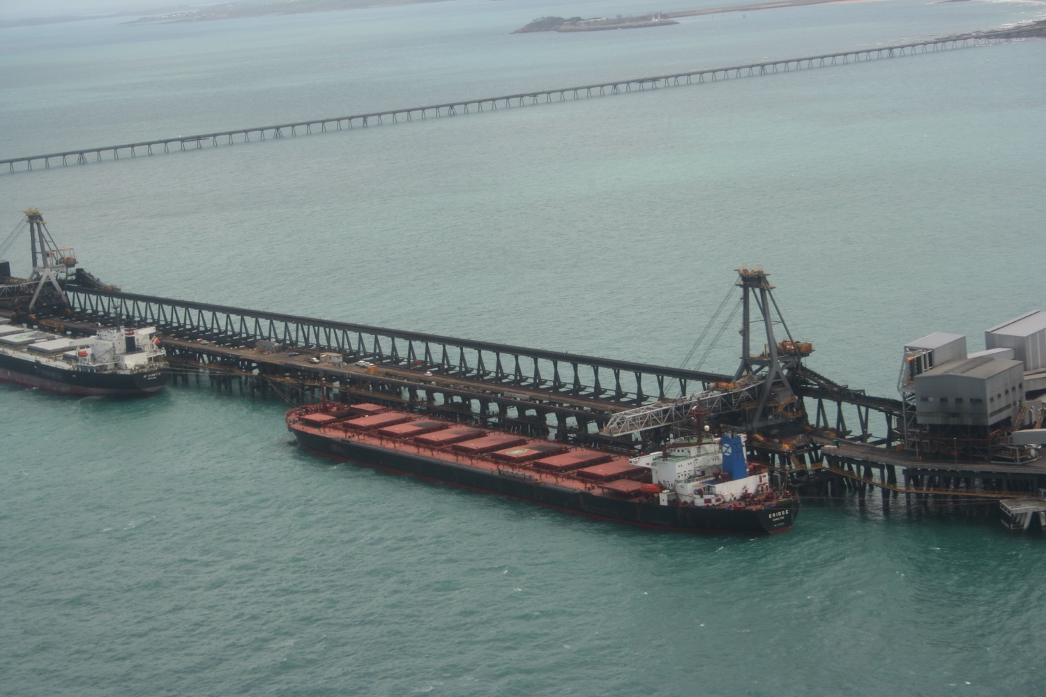 Bulk carriers at a coal-loading jetty